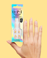 OPI Sticking Point Suzi’s Lemonade Stand press-on nails are held beside a manicured hand, showing nude almond tips with yellow lemon accents on a pale yellow background.