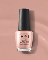 OPI France-y Seeing You Here nail lacquer bottle in a soft rosy nude shade with a black textured cap, displayed on a mauve pink background for fall nail colors.