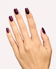 Hand modeling glossy deep plum shimmer nails painted with OPI Every Month is Oktoberfest nail lacquer, a rich shade for fall nail colors, on a clean light background.