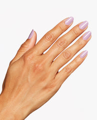 Hand shows a glossy pale lavender-pink manicure with OPI Mod About Me Nail Lacquer on rounded nails against a clean white background.